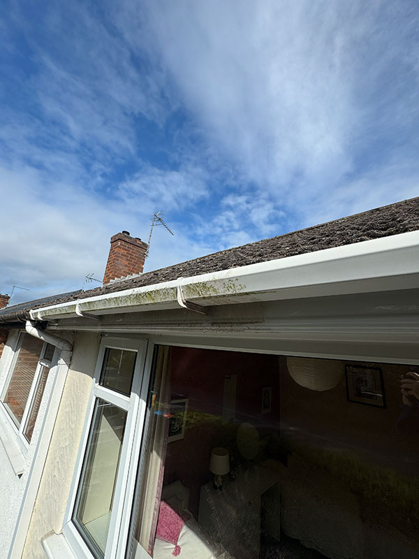 Before and after photo of gutter cleaning